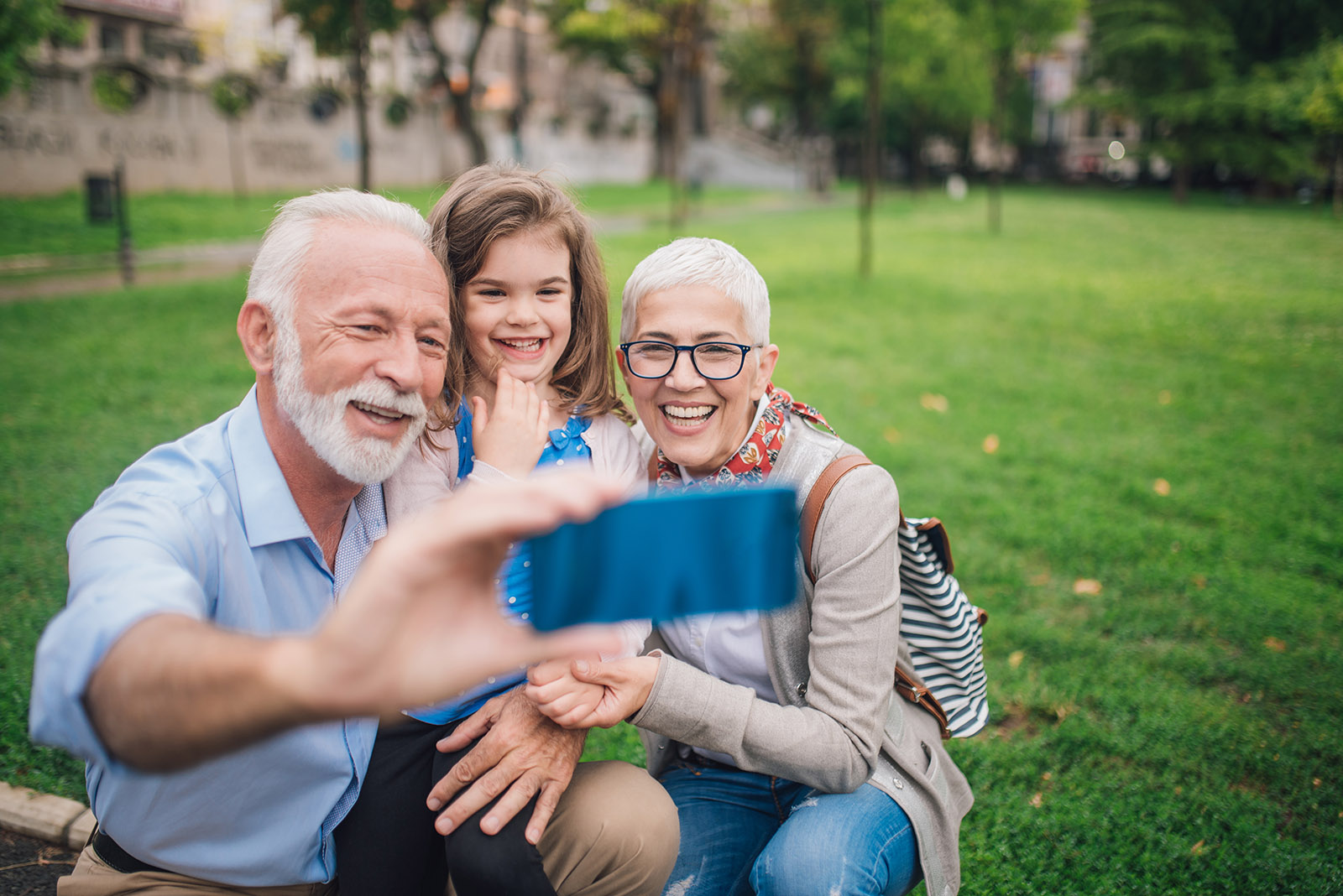 Grandfather, grandma and granddaughter taking a selfie New Homepage 7