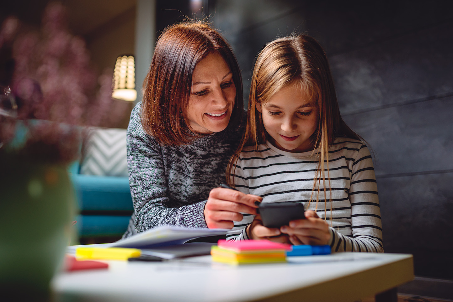 Mother and daughter using smart phone New Homepage 6